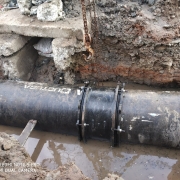 pipe laying at narrow concrete road