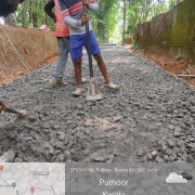 Pazhavara NSS road restoration - bed course laying C.C1:4:8 in progress.