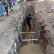 excavating earth with shoring for pipe laying